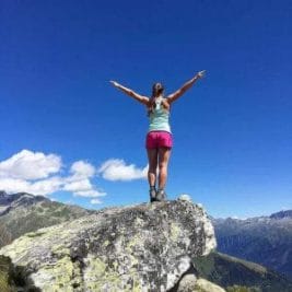 woman stands on a rock