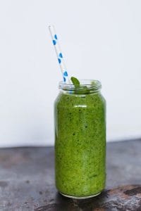 green smoothie with a straw