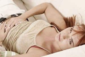 woman holds hands on her stomach