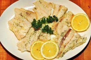 Fish with lemon slices on a plate
