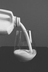 pour milk in a glass