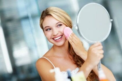 a woman washes off her make-up