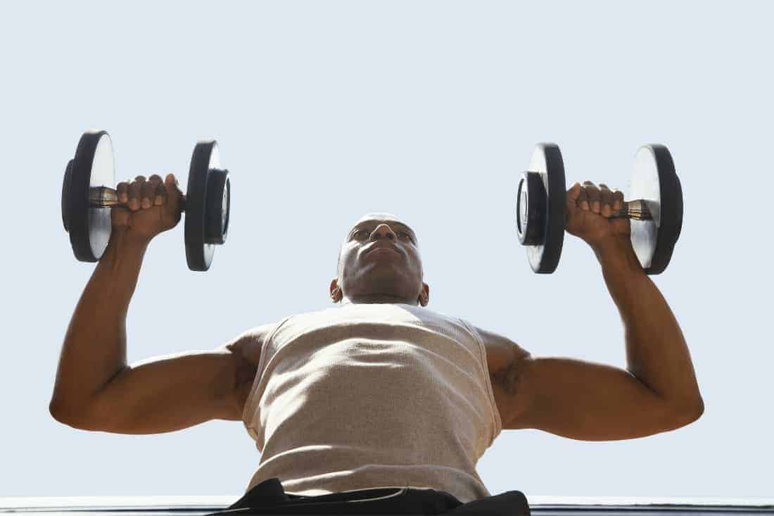man exercises with dumbbells