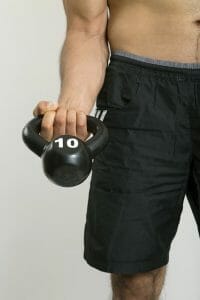 a man exercises with dumbbells