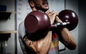 a man exercises with barbells