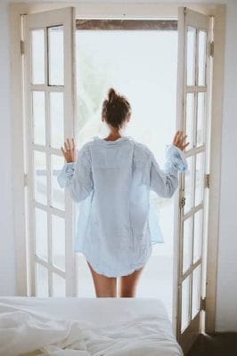 woman standing by the open door