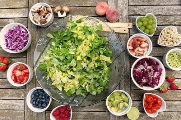 Vegetable salad and fruit in bowls