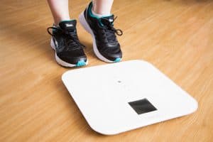 woman stepping on the scale