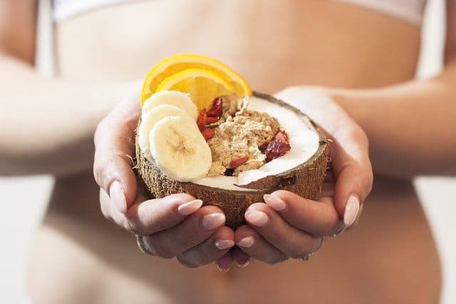 a woman holds a diet dessert in her hands