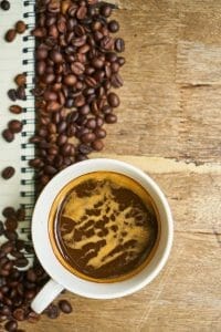 Coffee beans and coffee in a cup