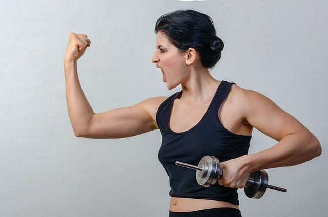 woman exercises with dumbbells