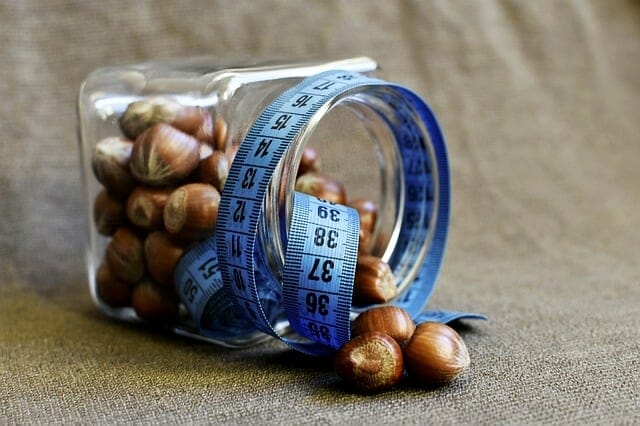 A jar of nuts wrapped in a measuring tape