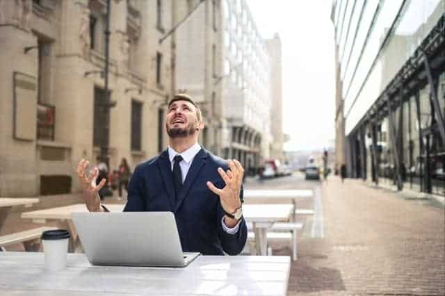 A nervous man working on his laptop