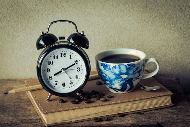  a cup of coffee and an alarm clock