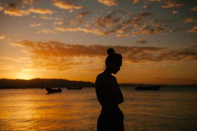 sad woman walking on the beach