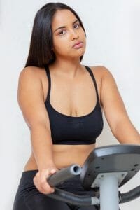 woman exercises on an exercise bike