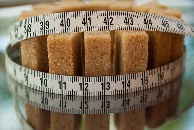 sugar cubes tied with a measuring cup