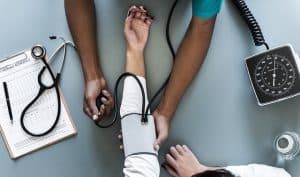 A doctor measuring a woman's blood pressure