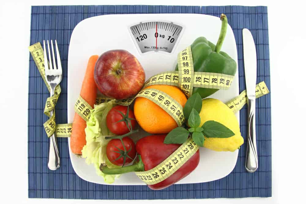 Vegetables and fruit on a plate with a centimeter