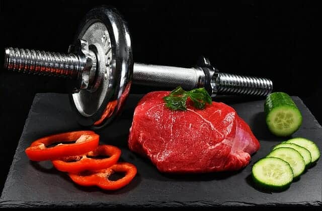  dumbbells, a piece of meat and vegetables