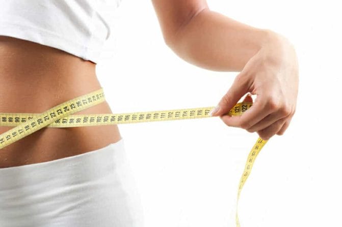 slim waist measured with a centimeter