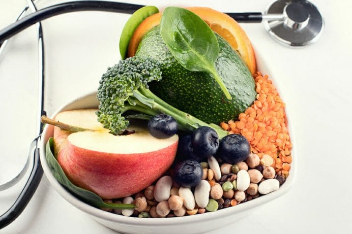  A bowl of healthy food, a stethoscope next to it