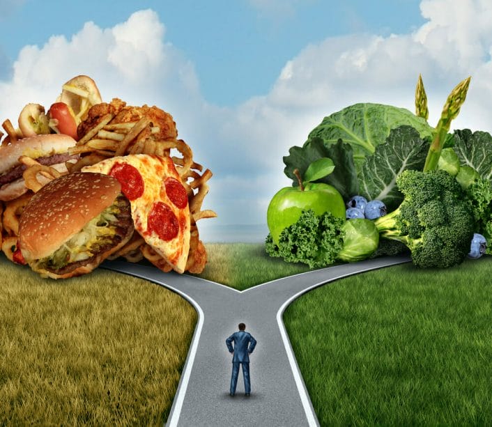  A man wonders whether to eat fast food or vegetables