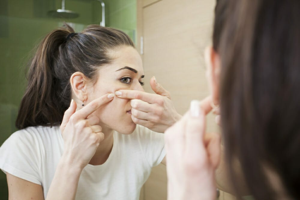  woman squeezes pimples