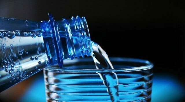  Water poured from a bottle into a glass