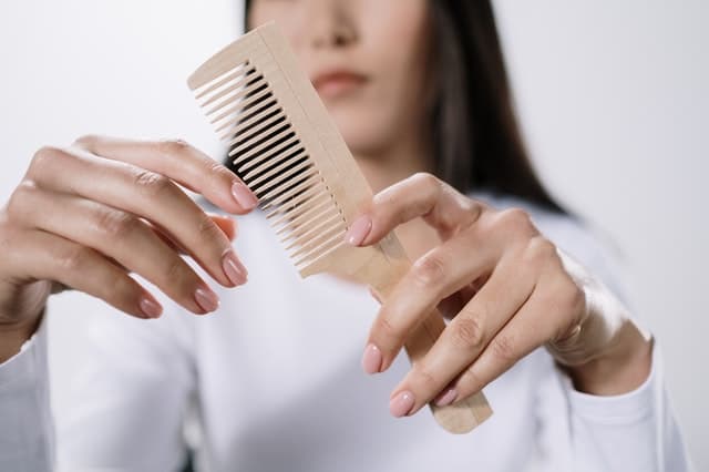  a woman clutching a comb in her hand