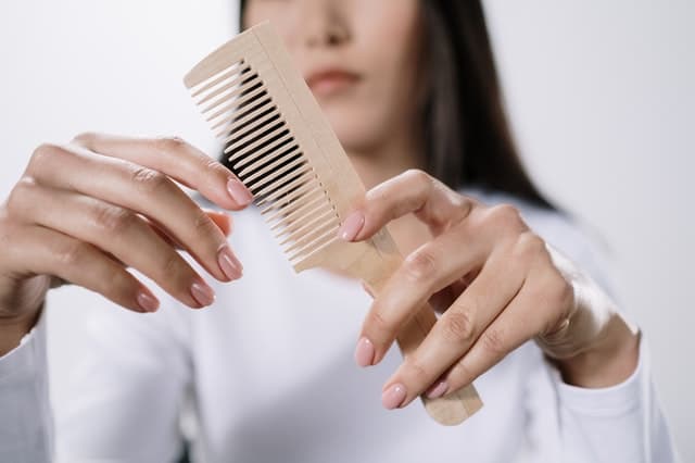 a woman clutching a comb in her hand
