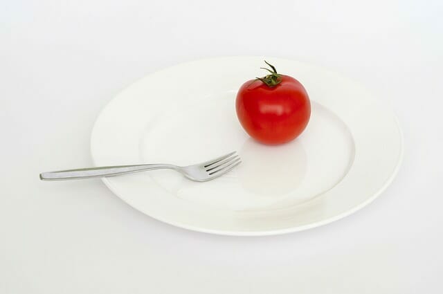  A tomato and a fork on your plate