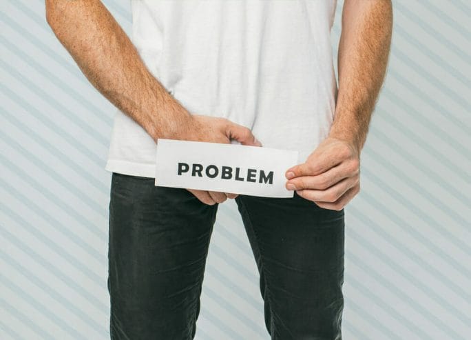 A man holds a piece of paper with the word