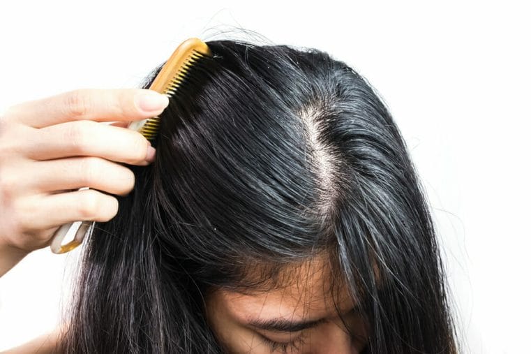  woman combs her hair