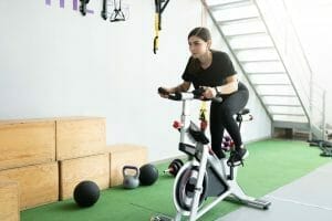  woman trains on stationary bike