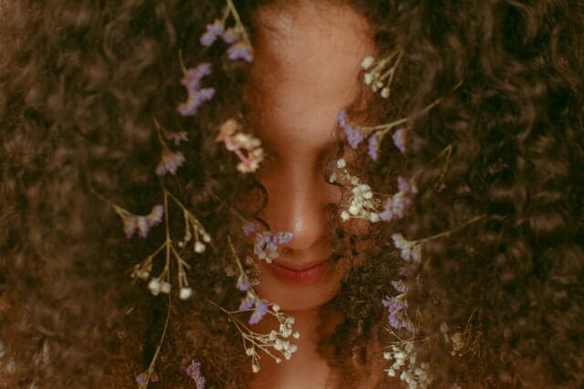 a woman with herbs woven into her hair