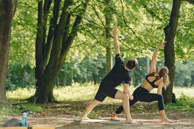  couple performs stretching exercises in the open air