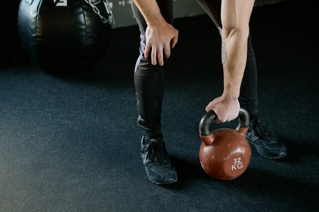 A man trains with weights at the gym