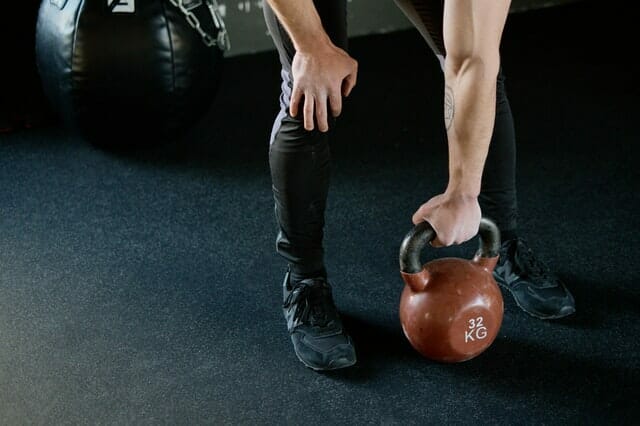  A man trains with weights at the gym