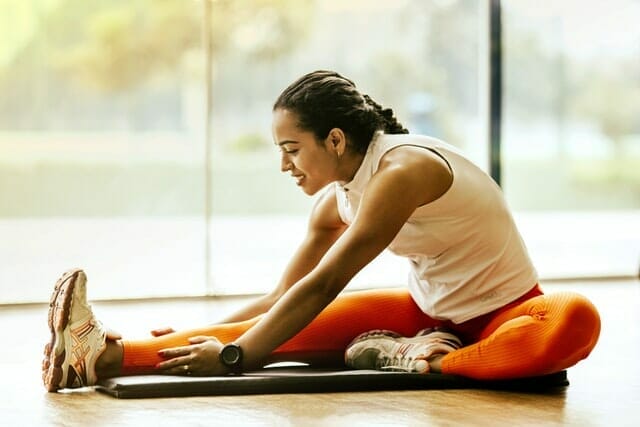  woman performs stretching exercises