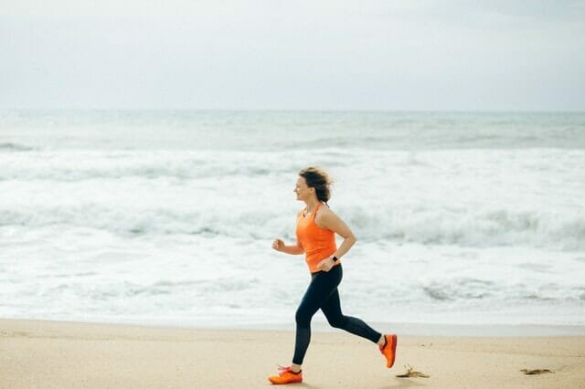  woman runs on the beach