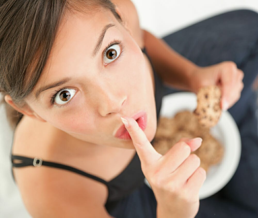 woman secretly eats sweets