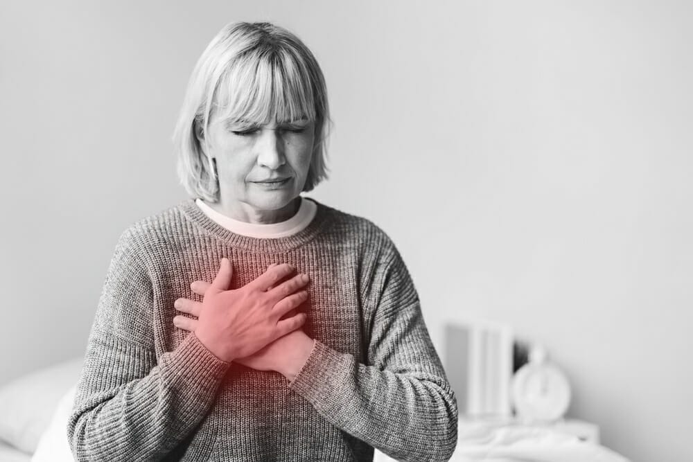 woman holds on to her heart