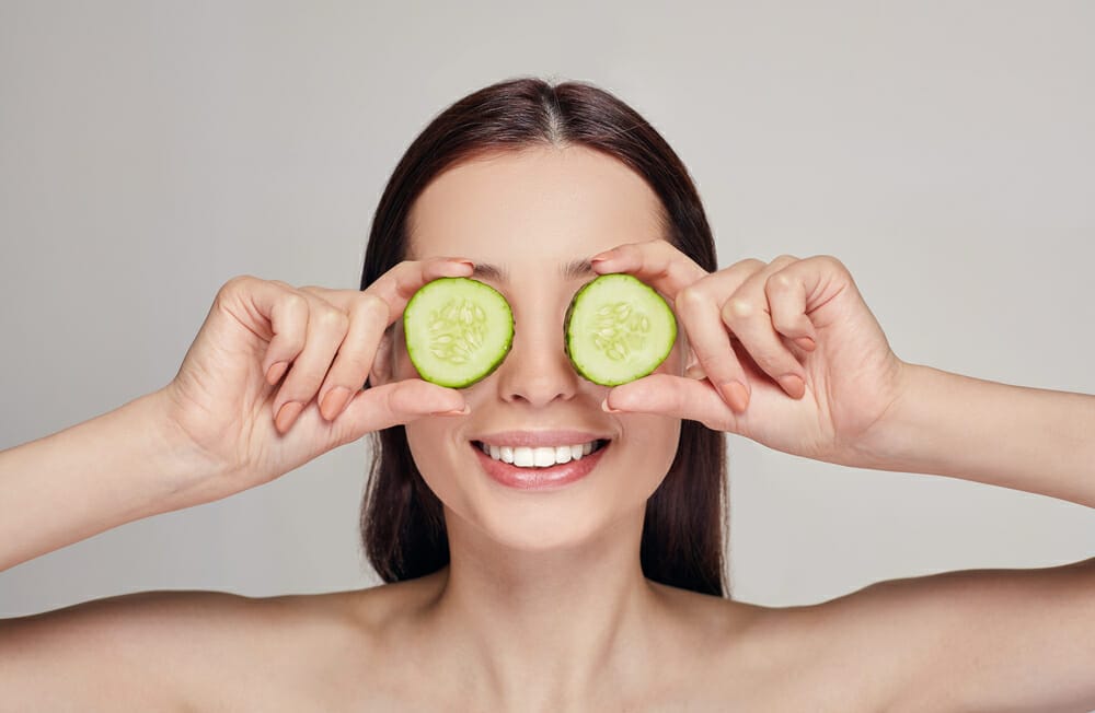  woman with cucumber slices on the eyes
