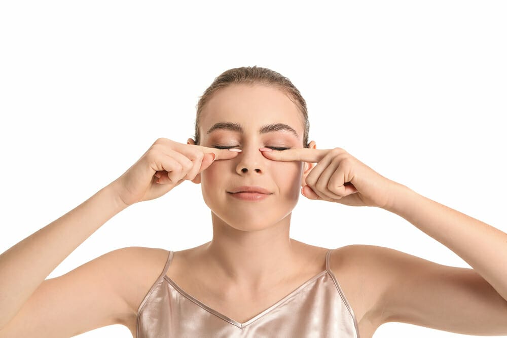 woman does facial muscle gymnastics