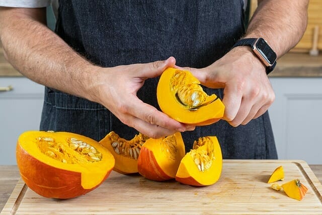 man peels pumpkin